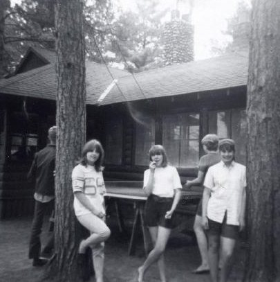 Lodge in the 1960s with campers outside playing table tennis